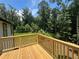 Wooden deck with wooded backyard view at 114 Jousters Ln, Lawrenceville, GA 30044