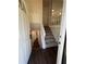 Entryway with stairs leading upstairs and dark hardwood floors at 114 Jousters Ln, Lawrenceville, GA 30044