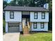 Two-story house with white siding and black accents at 114 Jousters Ln, Lawrenceville, GA 30044