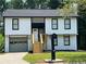 Recently updated two-story house, featuring white exterior and a gray garage at 114 Jousters Ln, Lawrenceville, GA 30044