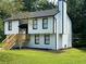Two-story house with white siding, black accents and a wooden deck at 114 Jousters Ln, Lawrenceville, GA 30044