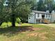 Recently renovated two-story home with white exterior and a large backyard at 114 Jousters Ln, Lawrenceville, GA 30044