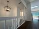 Bright hallway with white railings and dark hardwood floors at 114 Jousters Ln, Lawrenceville, GA 30044