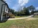 Two-story home with a deck, driveway, and mature trees at 114 Jousters Ln, Lawrenceville, GA 30044