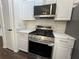 Stainless steel appliances and white shaker cabinets in kitchen at 114 Jousters Ln, Lawrenceville, GA 30044