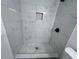 Modern shower with marble tile and pebble floor at 114 Jousters Ln, Lawrenceville, GA 30044
