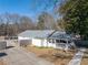 Aerial view showing a ranch house with a porch, driveway, and fenced backyard at 3170 New Macland Rd, Powder Springs, GA 30127