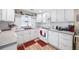 White kitchen with ample counter space, gas range, and stainless steel appliances at 3170 New Macland Rd, Powder Springs, GA 30127