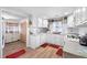 Bright kitchen features white cabinets, subway tile backsplash, and wood-look flooring at 3170 New Macland Rd, Powder Springs, GA 30127