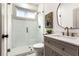 Modern bathroom featuring a glass enclosed shower, gray vanity, and updated fixtures at 1055 Ormewood Se Ave, Atlanta, GA 30316