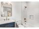 Bright bathroom featuring a tub with white subway tile surround and marble countertop at 1055 Ormewood Se Ave, Atlanta, GA 30316