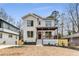 Charming two-story home with white painted brick, a covered porch, and professionally landscaped yard at 1055 Ormewood Se Ave, Atlanta, GA 30316