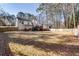 Spacious backyard with wooden fence, lawn, landscaping and multiple patio decks at 1775 Jody Ne Dr, Marietta, GA 30066