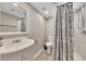 Bathroom featuring marble tile and shower with neutral walls and light wood floors at 1775 Jody Ne Dr, Marietta, GA 30066