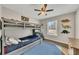 Charming bedroom featuring a gray bunk bed, 'ROAR' wall decor, and hardwood floors with a blue rug at 1775 Jody Ne Dr, Marietta, GA 30066