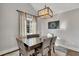 Dining room with a modern light fixture, neutral walls, and a large window for ample natural light at 1775 Jody Ne Dr, Marietta, GA 30066