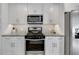 Close up of kitchen featuring stainless steel appliances, stone counters, and white cabinets at 1775 Jody Ne Dr, Marietta, GA 30066