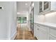 Butlers pantry with white shaker cabinets and stainless steel appliances at 2179 William Way, Atlanta, GA 30345