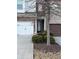 Townhome entrance with a stone facade and landscaping at 3144 Spicy Cedar Ln, Lithonia, GA 30038