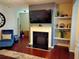 Living room with fireplace, built-in shelving, and hardwood floors at 3144 Spicy Cedar Ln, Lithonia, GA 30038