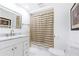Clean bathroom with white vanity, bathtub and striped shower curtain at 3000 Leeds Garden Ln, Alpharetta, GA 30022