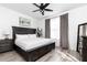 Serene bedroom with king-size bed, dark wood furniture, and grey curtains at 3000 Leeds Garden Ln, Alpharetta, GA 30022