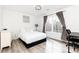 Cozy bedroom with a queen bed and large window at 3000 Leeds Garden Ln, Alpharetta, GA 30022