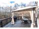Relaxing deck with gazebo, patio furniture, and wooded views at 3000 Leeds Garden Ln, Alpharetta, GA 30022
