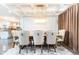 Bright dining room with a large table, coffered ceiling, and chandelier at 3000 Leeds Garden Ln, Alpharetta, GA 30022