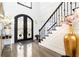 Spacious entryway with hardwood floors, a grand staircase, and double doors at 3000 Leeds Garden Ln, Alpharetta, GA 30022