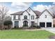 Stunning two-story home with black accents and a manicured lawn at 3000 Leeds Garden Ln, Alpharetta, GA 30022