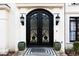 Elegant black double front doors with ornate ironwork at 3000 Leeds Garden Ln, Alpharetta, GA 30022
