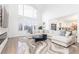 Large Gathering room with a sectional sofa, fireplace, and large windows at 3000 Leeds Garden Ln, Alpharetta, GA 30022