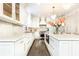 Bright kitchen with white cabinets, quartz countertops, and stainless steel appliances at 3000 Leeds Garden Ln, Alpharetta, GA 30022