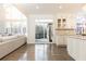 Open concept kitchen and living area with hardwood floors and sliding glass doors at 3000 Leeds Garden Ln, Alpharetta, GA 30022