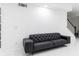 Modern living room showcasing a black tufted sofa at 3000 Leeds Garden Ln, Alpharetta, GA 30022