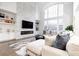 Spacious living room with a large sectional sofa and a stunning stone fireplace at 3000 Leeds Garden Ln, Alpharetta, GA 30022