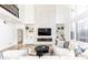 Bright and airy living room featuring a large sectional sofa and a floor-to-ceiling fireplace at 3000 Leeds Garden Ln, Alpharetta, GA 30022