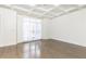 Spacious living room with hardwood floors and coffered ceiling at 3000 Leeds Garden Ln, Alpharetta, GA 30022