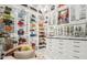Spacious Primary closet with glass shelving and designer handbags at 3000 Leeds Garden Ln, Alpharetta, GA 30022