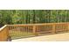 Spacious back deck showcasing wooden railing and an expansive outdoor view at 4515 Aiden Way, Cumming, GA 30041