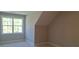Cozy bedroom with plush carpeting, natural lighting, and neutral color scheme at 4515 Aiden Way, Cumming, GA 30041