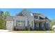 Charming home with light gray siding, brick accents, manicured lawn, and a two car garage at 4515 Aiden Way, Cumming, GA 30041