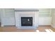 Living room features a stylish fireplace with marble surround and built-in shelving on either side at 4515 Aiden Way, Cumming, GA 30041