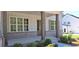 Inviting front exterior with brick base, wood columns, board and batten siding, and professionally landscaped at 4515 Aiden Way, Cumming, GA 30041