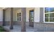 Charming front porch with brick base, natural wood columns, and craftsman-style front door at 4515 Aiden Way, Cumming, GA 30041