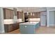 Modern kitchen featuring stainless steel appliances, an island, and custom cabinetry at 4515 Aiden Way, Cumming, GA 30041
