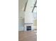 Spacious living room with vaulted ceilings, ceiling fan, fireplace and built in shelving for storage and decor at 4515 Aiden Way, Cumming, GA 30041