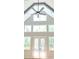 Bright living room with vaulted ceiling, fan, large windows, and doors leading to outdoor space at 4515 Aiden Way, Cumming, GA 30041