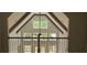 Open-concept great room with exposed beams, vaulted ceilings, large windows, and a view of the outdoors at 4515 Aiden Way, Cumming, GA 30041